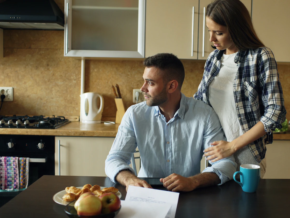Couple going over paperwork at their kitchen table