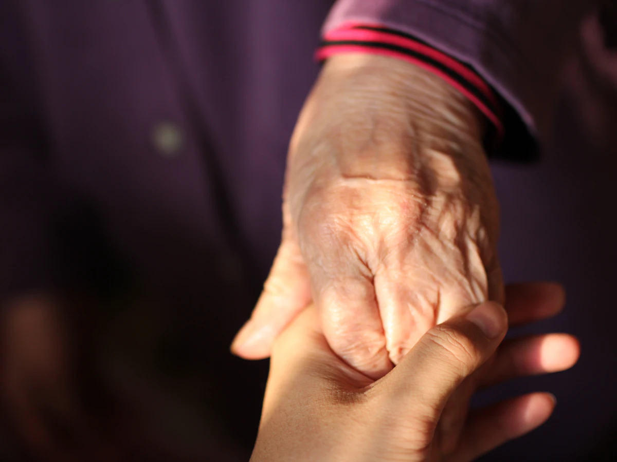 Holding an older person's hand