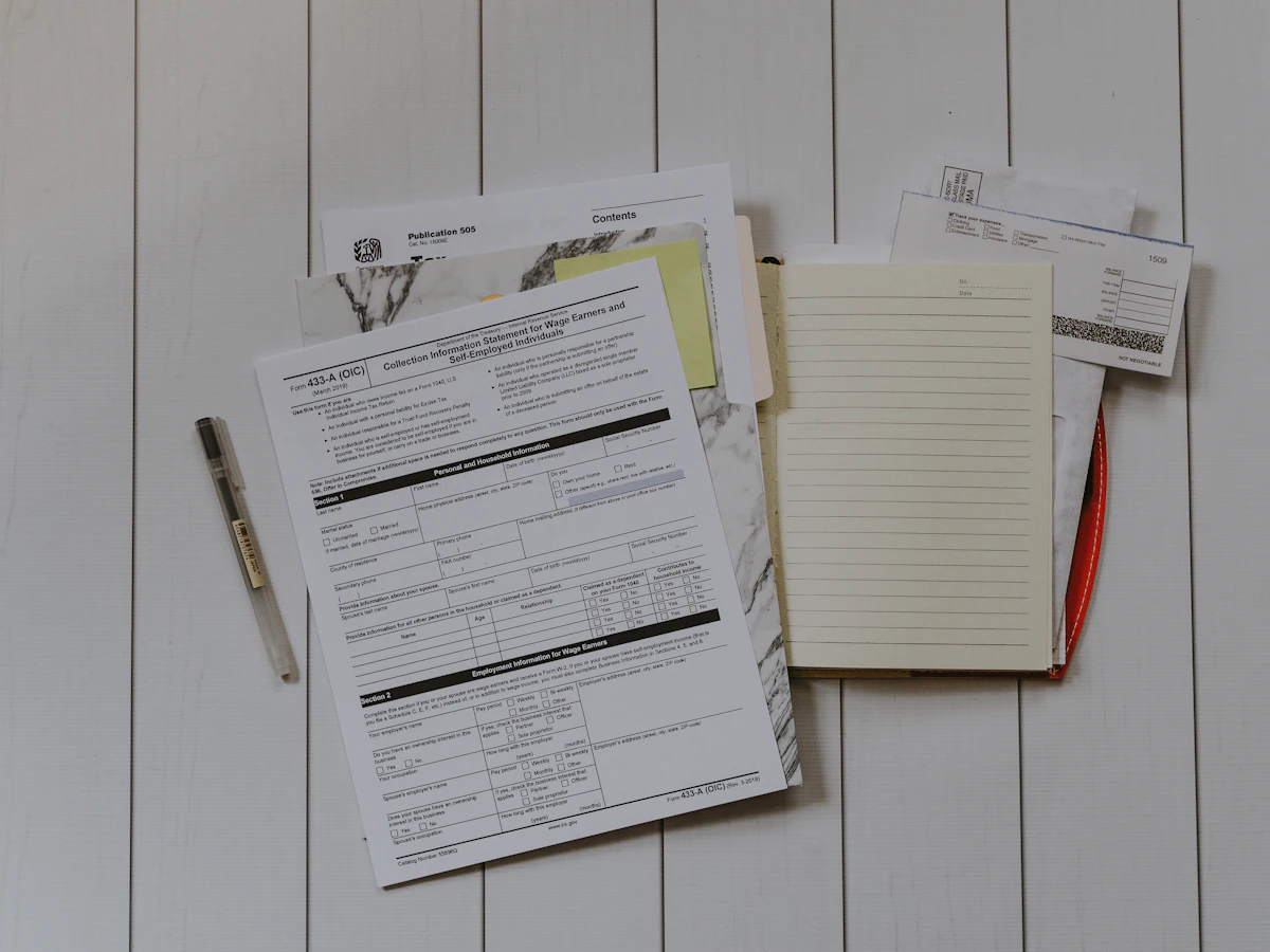 Stack of property paperwork and forms on a desk